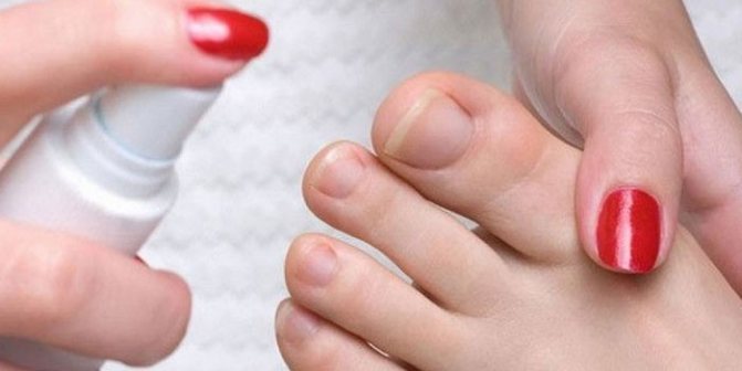 A girl treats her foot with a spray against nail fungus