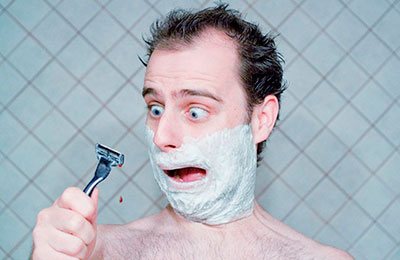 man cuts himself while shaving